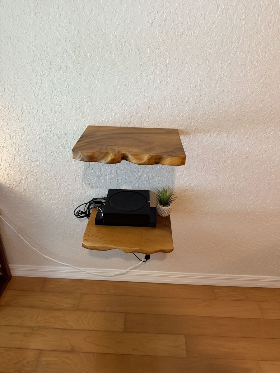 Live-edge floating shelves mounted on a textured wall in Seminole, FL